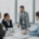 HR professionals and business leaders discussing workforce strategy in a modern office.